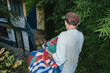 © Laura Herrera/Stocksy - Moving: Man carrying personal items down stairs during