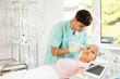 © JackF - Using device and hydrogen oxygen cleaning attachment, young specialist meticulously performs procedure, improving texture and appearance of young woman's skin.