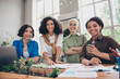 © deagreez - Photo of lovely four businessladies meeting community brainstorming business plan startup meeting office interior