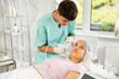 © JackF - Young male cosmetologist performs hardware facial whitening procedure to young female patient
