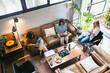 © Pedro Merino/Stocksy - Coworkers having coffee in a coworking space