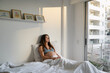 © Artem Zhushman/Stocksy - Pregnant woman relaxing in cozy morning bedroom