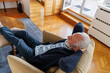 © Jovo Jovanovic/Stocksy - Retired senior man relaxing on couch at home