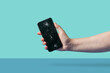 © Yaroslav Danylchenko/Stocksy - Person showing black smartphone with crashed display in studio