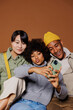 © BONNINSTUDIO/Stocksy - Three diverse friends making funny faces taking a selfie
