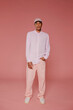 © BONNINSTUDIO/Stocksy - Young model posing wearing casual pink outfit and baseball cap