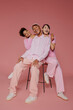 © BONNINSTUDIO/Stocksy - Diverse team smiling and posing on pink background