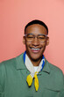 © BONNINSTUDIO/Stocksy - Man smiling and looking at camera on coral background