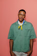 © BONNINSTUDIO/Stocksy - Man with glasses and bandana posing on coral background