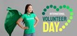 © Pixel-Shot - Female volunteer in superhero cape on grey background. Banner for International Volunteer Day