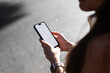 © Adrian Rodd/Stocksy - Hands of an anonymous woman using her smartphone during a sunny day