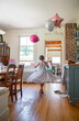 © Cara Dolan/Stocksy - Girl in pretty new dress and balloons has a birthday party at home