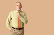 © Pixel-Shot - Handsome mature man with stylish tie on beige background