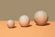 © Juan Moyano/Stocksy - wooden balls of different sizes side by side