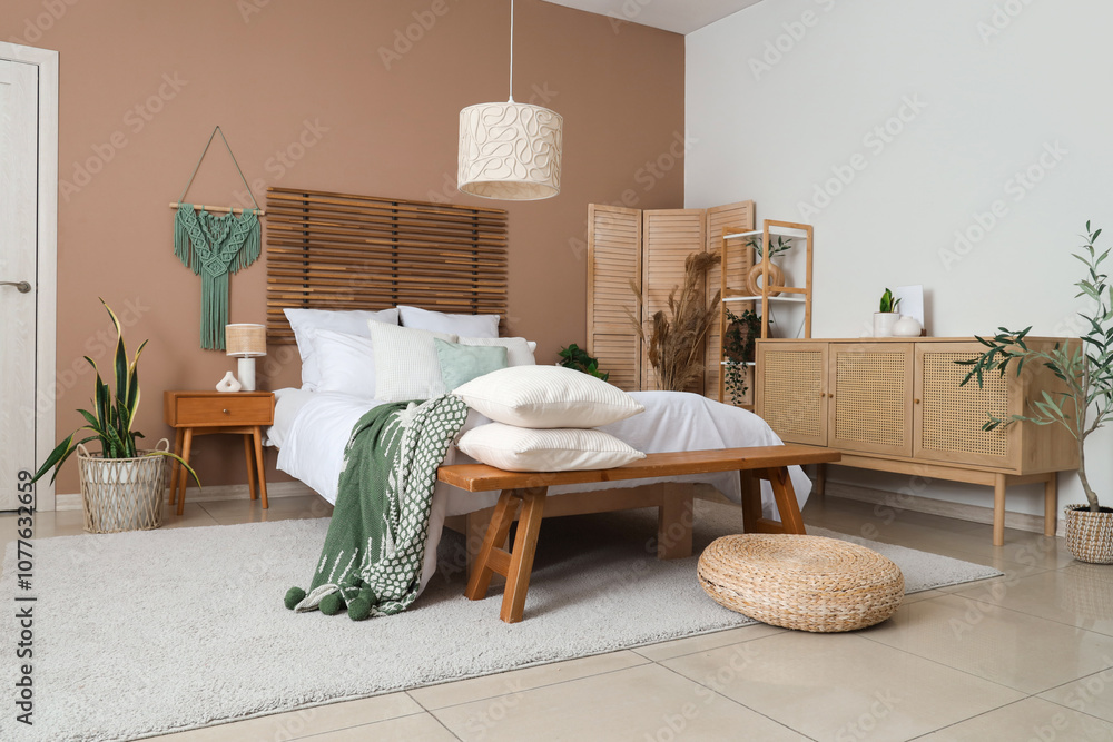 Bench with pillows in stylish interior of bedroom
