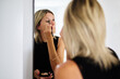 © Guille Faingold/Stocksy - Applying Makeup in a Bright Bathroom Mirror