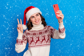 Wall Mural - Photo of charming lady wear ugly sweater use social media app make self picture video record v-sign isolated on blue color background