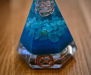 High resolution image of a single isolated beautiful one of a kind hand made Orgone pyramid generator containing crystals