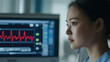 © INT888 - medical professional observing heart rate monitor with focus and calmness. monitor displays red heartbeat graph, indicating vital signs