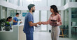 © peopleimages.com - Doctor, meeting and tablet with handshake for contract, agreement or hiring nurse at hospital. Man, woman or medical colleagues shaking hands for recruitment, deal or teamwork together at clinic