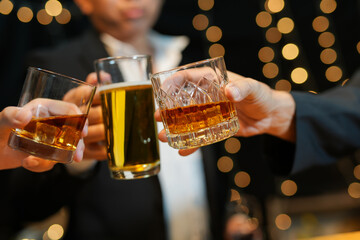 Wall Mural - food and drink male friends are happy drinking beer and clinking glasses at a bar or pub.