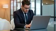 © velikiyzayats - Professional Man in Business Suit Working on Laptop in Modern Office Setting, Ideal for Business Marketing and Corporate Branding