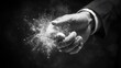 © Орися Зигмунд - A close-up of a male hand releasing a cloud of sparkling dust against a dark background.