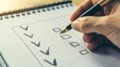 © I&Y - First-person perspective of a hand using a pen to mark checkboxes on a clean, organized checklist, symbolizing task completion and productivity.