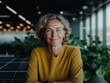 © Amy - Happy Senior Woman in yellow Sweater Sitting in Bright Modern Office