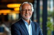 © Phoenix AI Photo - Soft focus portrait of an elderly CEO, his kind face and professional suit blending softly into the background, giving a dreamy, warm atmosphere