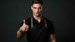 © Julia Jones - Confident young male chef giving thumbs up gesture in uniform and apron