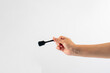 © apinya - Black ice cream spoon in hand on white background