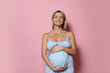© New Africa - Portrait of beautiful pregnant woman on pink background