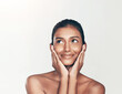 © peopleimages.com - Happy, beauty and Indian woman in studio thinking with skincare, ideas and natural makeup. Smile, wow and face of confident girl with inspiration, cosmetics and dermatology on white background space
