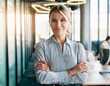 © OceanProd - portrait of cheerful business woman confident blonde caucasian businesswoman arms crossed interior modern office