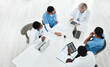 © peopleimages.com - Doctor, team and medical meeting in boardroom with CT scan for brain analysis, surgery planning or top view. Radiology, diversity and people with healthcare xray for health assessment of cancer tumor