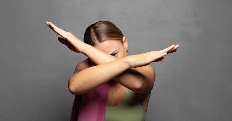 Canvas Print - covering face with hand and putting other hand up front to stop camera, refusing photos or pictures