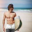 © peopleimages.com - Holiday, man and happy with surfboard on beach for travel adventure, water sport and summer vacation fun. Surfing, person and topless by ocean for fitness hobby, training exercise or leisure activity