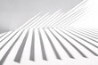 © youriy - Dynamic sharp striped shadows on a white surface forming geometric patterns with strong contrast and a minimalistic aesthetic