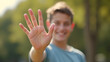© Arief - Happy man giving a high five in a sunny park