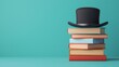 © Png - Video - Photo - A whimsical stack of colorful books topped with a classic black top hat on a turquoise background.
