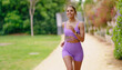 © Friends Stock - A Joyful Woman is Running in Nature While Dressed in Stylish and Comfortable Activewear