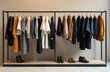 © Slepitssskaya - A modern clothing rack showcases various styles of apparel and shoes in a chic boutique environment.
