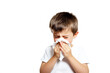 © Erik González - A young boy is blowing his nose with a tissue