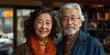 © Asad - Portrait of asian senior couple sitting in coffee shop and smiling