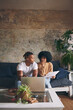 © peopleimages.com - Home, budget and couple with laptop, thinking and documents for tax report on sofa. Research, man and woman on couch with financial planning paperwork, mortgage bills or online app for savings growth