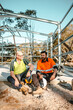 © Austockphoto - Construction workers sitting on the cemented floor.