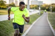 © SerPak - A man in a bright green athletic shirt enjoys a run along a park path on a sunny day. His smile reflects both the joy of exercise and the beauty of the outdoor environment. The city skyline is visible
