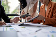 © Wasana - Business team analyzing financial data and taking notes in meeting