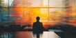 © StockUp - A businessman sits in a modern office as vivid city lights blur through the window, creating a dynamic effect.